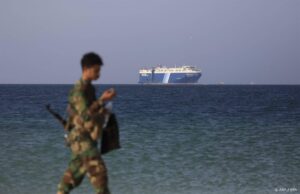 epa11012877 A Houthi soldier walks through the beach with the Galaxy Leader cargo ship in the background, seized by the Houthis offshore of the Al-Salif port on the Red Sea in the province of Hodeidah, Yemen, 05 December 2023. The Galaxy Leader ship, reportedly linked to an Israeli businessman, was seized and re-routed to offshore of the Yemeni port of Al-Salif by the Houthis on 19 November 2023 in retaliation for Israel's airstrikes on the Gaza Strip, according to statements by the Houthis. The ship, carrying around 25 crew members belonging to various nations, was seized as it was on its way to India. The Houthis, who control most of Yemen 's Red Sea coast, have fired missiles and drones at Israel and attacked more vessels transiting the area. Thousands of Israelis and Palestinians have died since the militant group Hamas launched an unprecedented attack on Israel from the Gaza Strip on 07 October, and the Israeli strikes on the Palestinian enclave which followed it.  EPA/YAHYA ARHAB