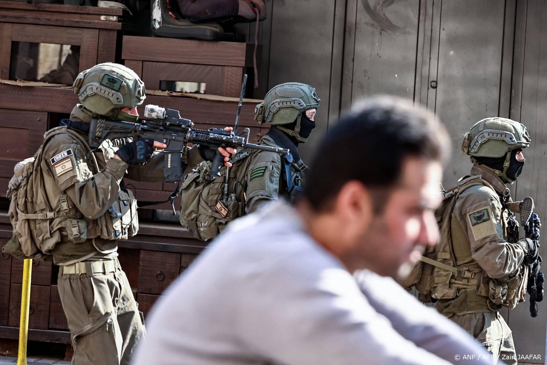 Israeli soldiers walk past a man during a military operation in the town of Qalqiya, in the occupied West Bank on December 4, 2025.
Zain JAAFAR / AFP