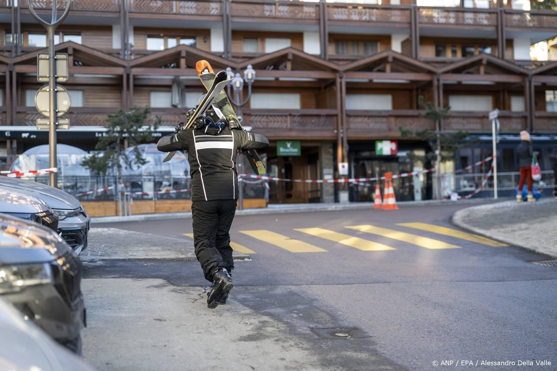epa12620173 A skier walks in a street near the site where a fire broke out at the Le Constellation bar and lounge following an explosion in the early hours of New Year's Eve, in Crans-Montana, Switzerland, 01 January 2026. According to regional media, the incident caused several deaths and injuries, while the exact cause of the blaze was not immediately known, Swiss cantonal police said. EPA/ALESSANDRO DELLA VALLE